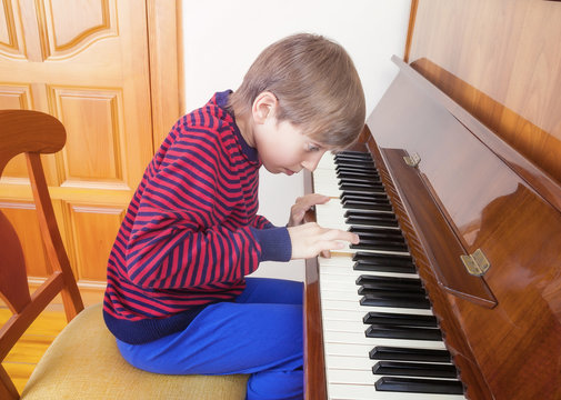 Funny little child playing piano