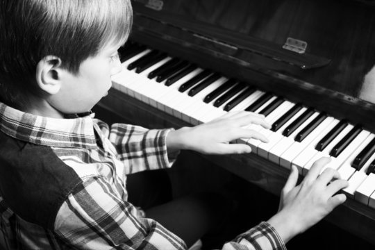 Beautiful child playing piano (black and white)