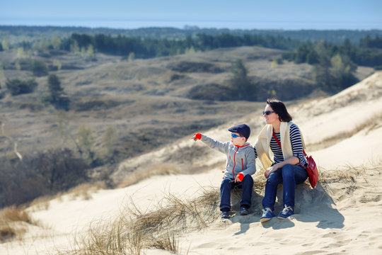 Mother and son together on sand Dunes in Neringa