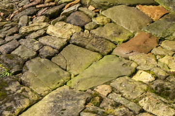 Cobblestone pavement in wet weather closeup as background