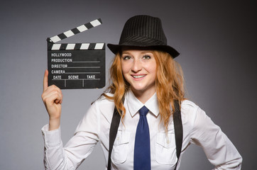 Young woman with movie board