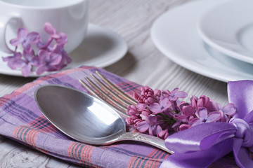 Elegant table setting for breakfast, with flowers lilacs © FomaA