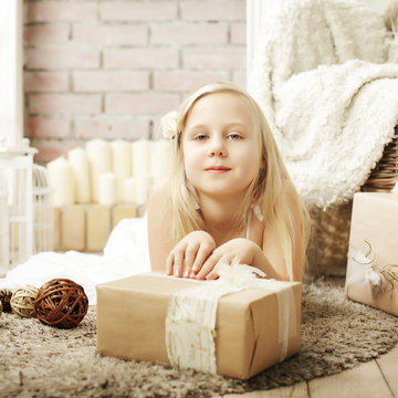 Cute little girl with present at home
