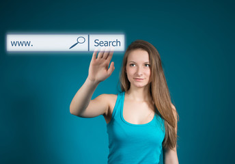 Young woman pointing at search bar on virtual screen.