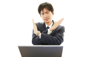 禁止の意思表示をするビジネスマン