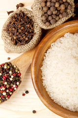 spices with rice on a wooden surface