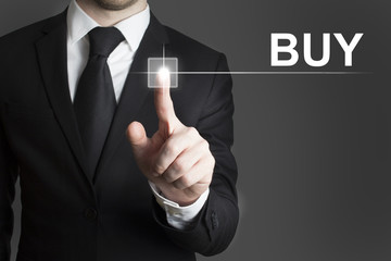 businessman pressing virtual button buy