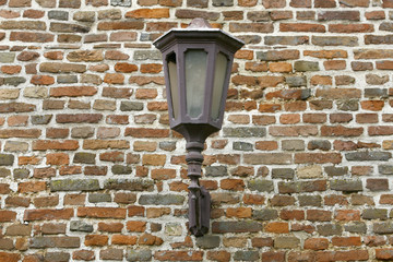 Old lantern on the brick wall