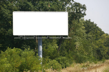 Empty billboard on background of sunset sky