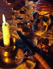 Pirate theme with skull, knife, treasure map and gold coins.