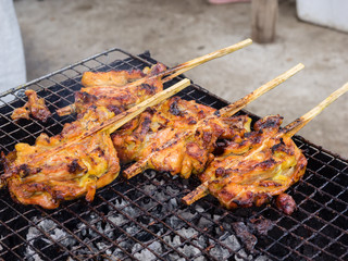 Grilling chicken plugged with bamboo