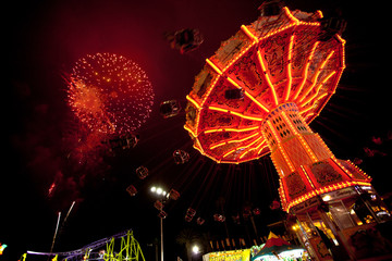 Carnival Swing Ride Under Fireworks
