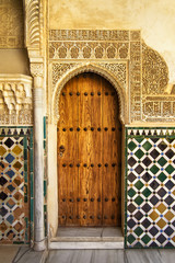 A door decorated in arabic style in La Alhambra, Granada, Spain - obrazy, fototapety, plakaty