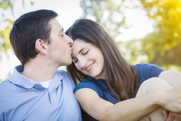 Young Attractive Couple Smooching in the Park