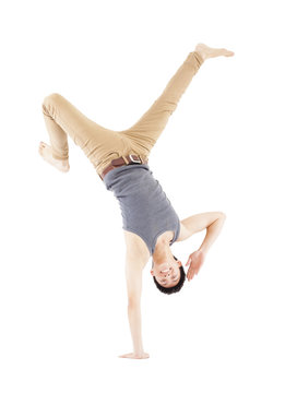 Young man dancing a breakdance and handstand pose
