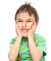 Portrait of a cute boy playing with paints