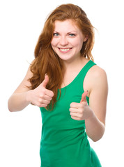 Woman is showing thumb up gesture