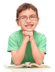 Little boy is reading a book