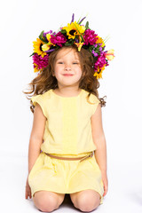 portrait of playful girl  wreath of flowers