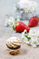 Cookie filled with strawberry jam. Beautiful blooming crataegus