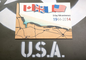 commemorative card of D-Day on the hood of a military vehicle