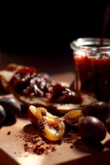 Plum jam in a transparent jar