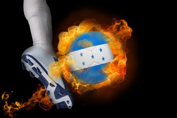 Football player kicking flaming honduras flag ball
