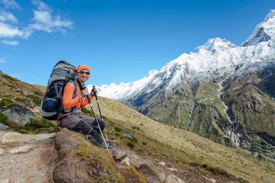 Hiker rests on trek in Himalayas, Nepal