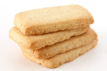 Butter biscuits in a stack on a white surface.