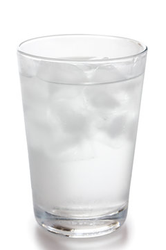 Detail of a simple glass of water with floating ice cubes