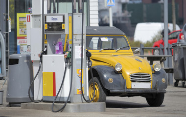 Old car at a gas station