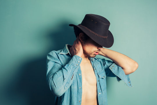 Sexy young cowboy with open shirt