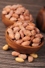 Salted roasted peanuts in wooden bowl