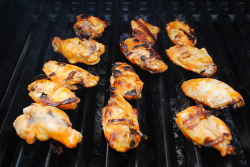 Spicy Buffalo Wings Cooking on a Summer Grill