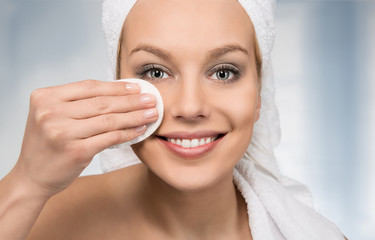 Happy attractive women removing makeup