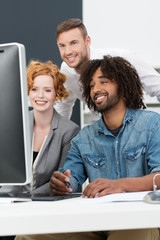 junges team schaut auf computer-monitor