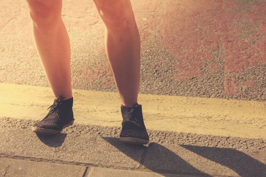Closeup on a young woman's legs in the street