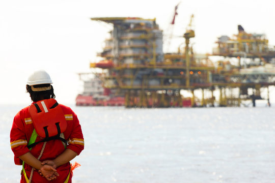 Rig Worker And An Oil Platform