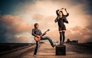 guitarist and dancer at rural sunset road