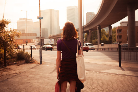 Young woman walking by the roadside