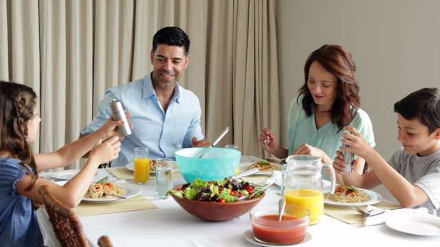 Family having a spaghetti dinner together