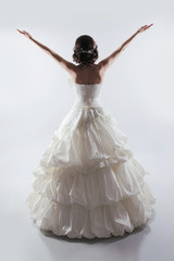 Naklejka premium Beautiful Bride open arms wearing in gorgeous wedding dress. Fas