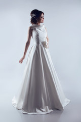 Fototapeta na wymiar Beautiful Bride in elegant wedding dress. Fashion lady. Studio p