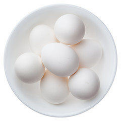 White eggs in a bowl isolated on white background