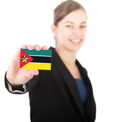 business woman holding a card with the flag of Mozambique