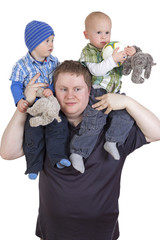 Father carrying his twin children on shoulders