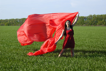 young lady in red dress on field