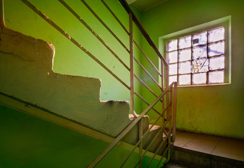 A staircase with a window in an old soviet building in Ukraine