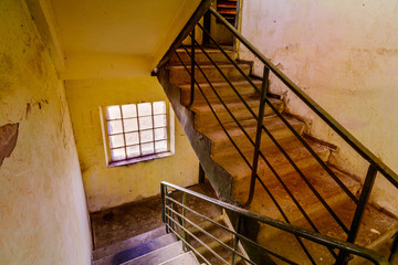 A staircase with a window in an old soviet building in Ukraine