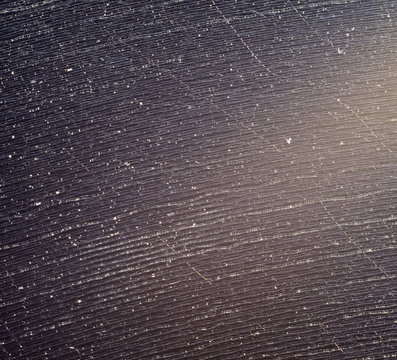 Close up black vinyl microgroove, it is clear the dust nested